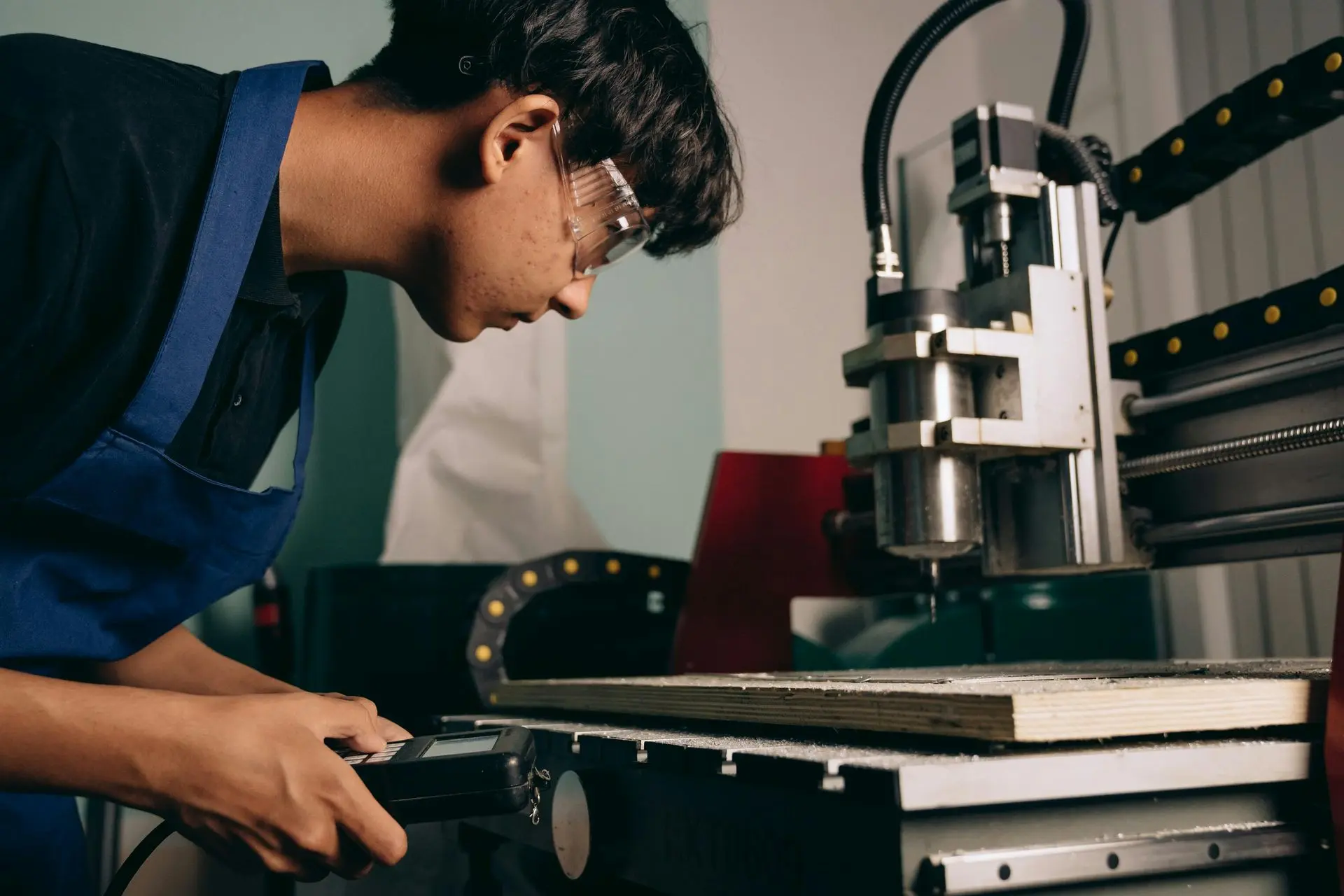 Engineer operating CNC machine to create functional prototype during product development process in China