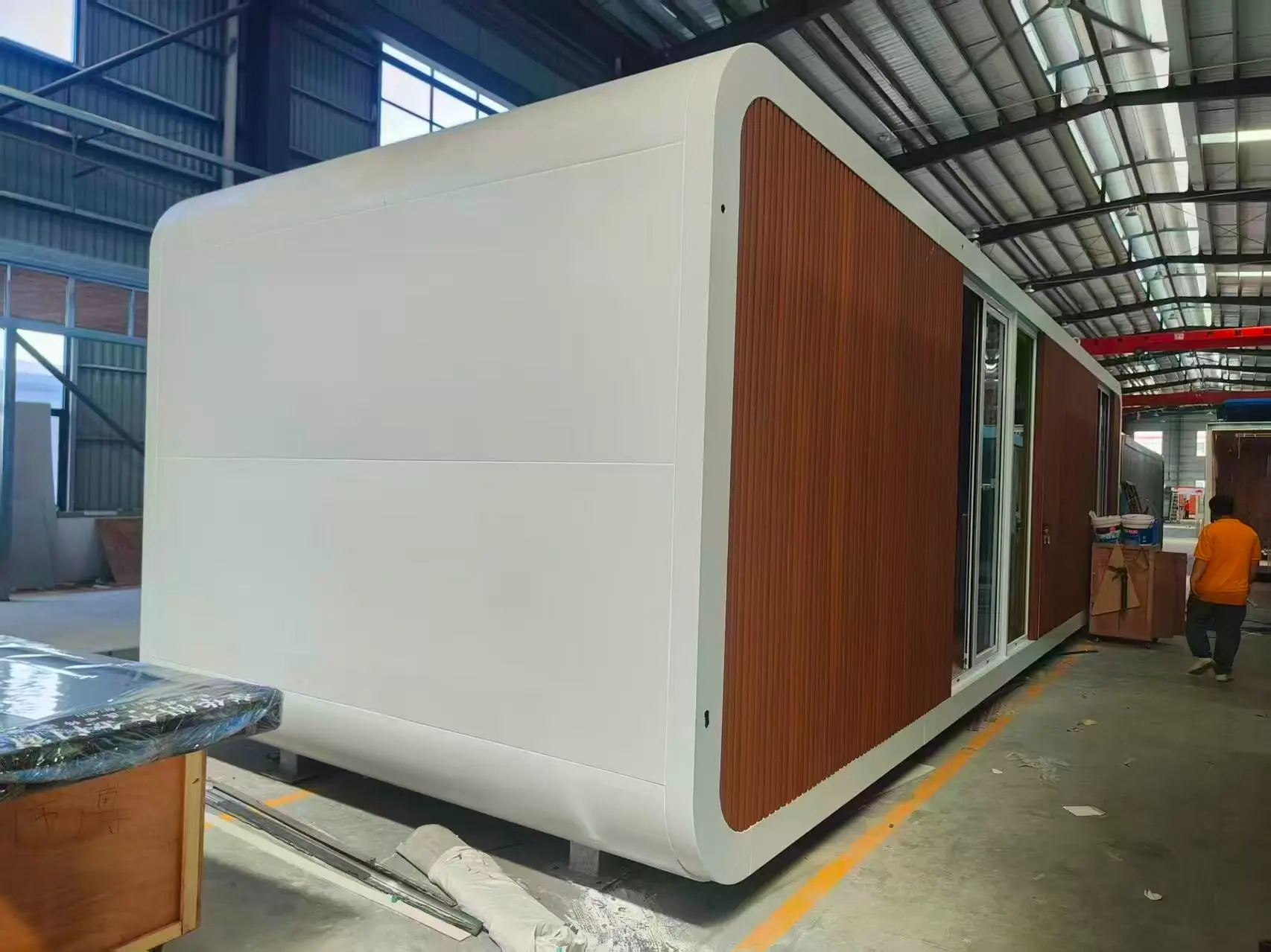 China Prefab House Modular Cabin Manufacturing Process China prefab house modular cabin unit being assembled inside factory with modern exterior panels
