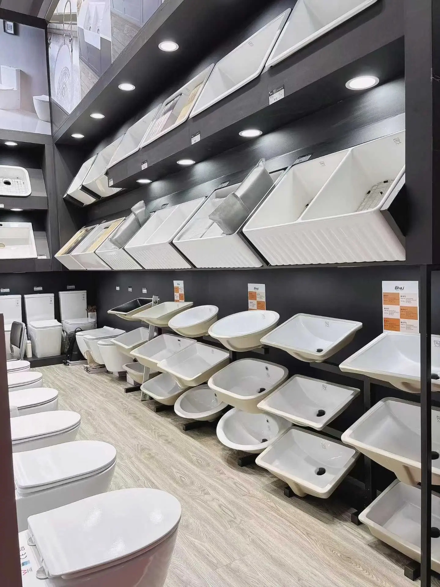 Sanitary ware shipping display showing ceramic sinks, wash basins, and toilets in showroom for export and bulk transport