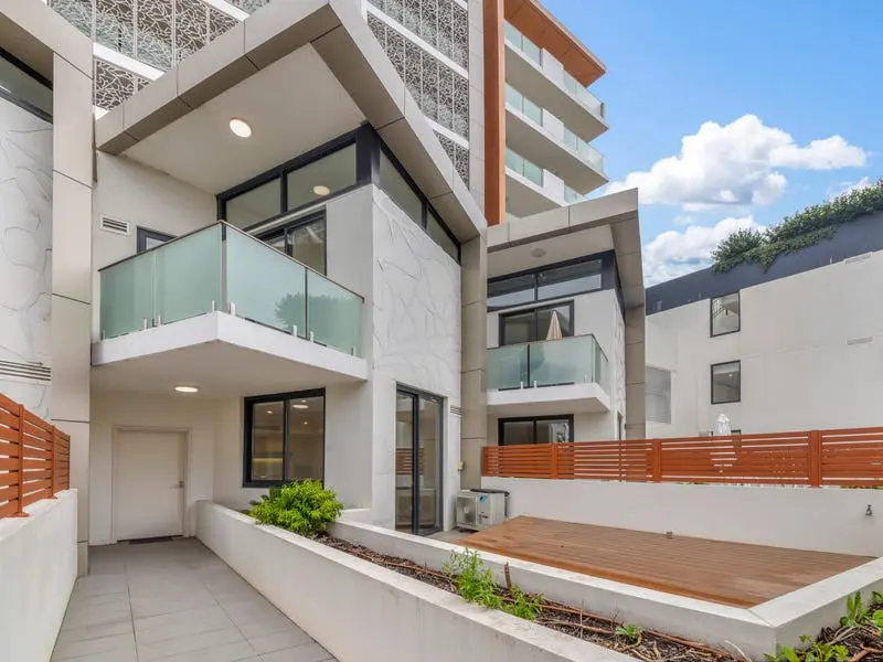 Modern residential building with glass balcony railings sourced from China, featuring sleek design and outdoor deck area