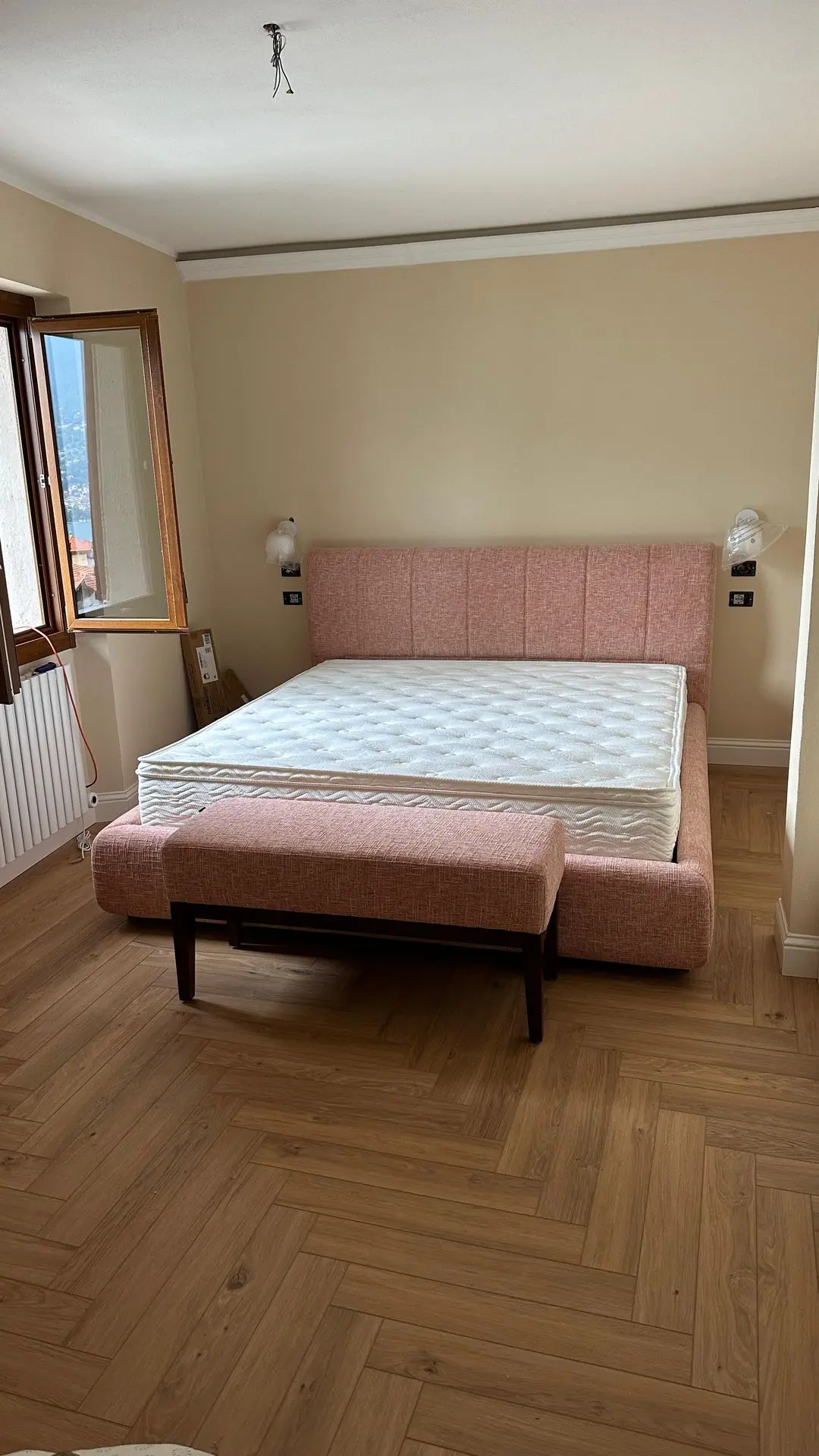 Lake Como hotel bedroom with upholstered bed