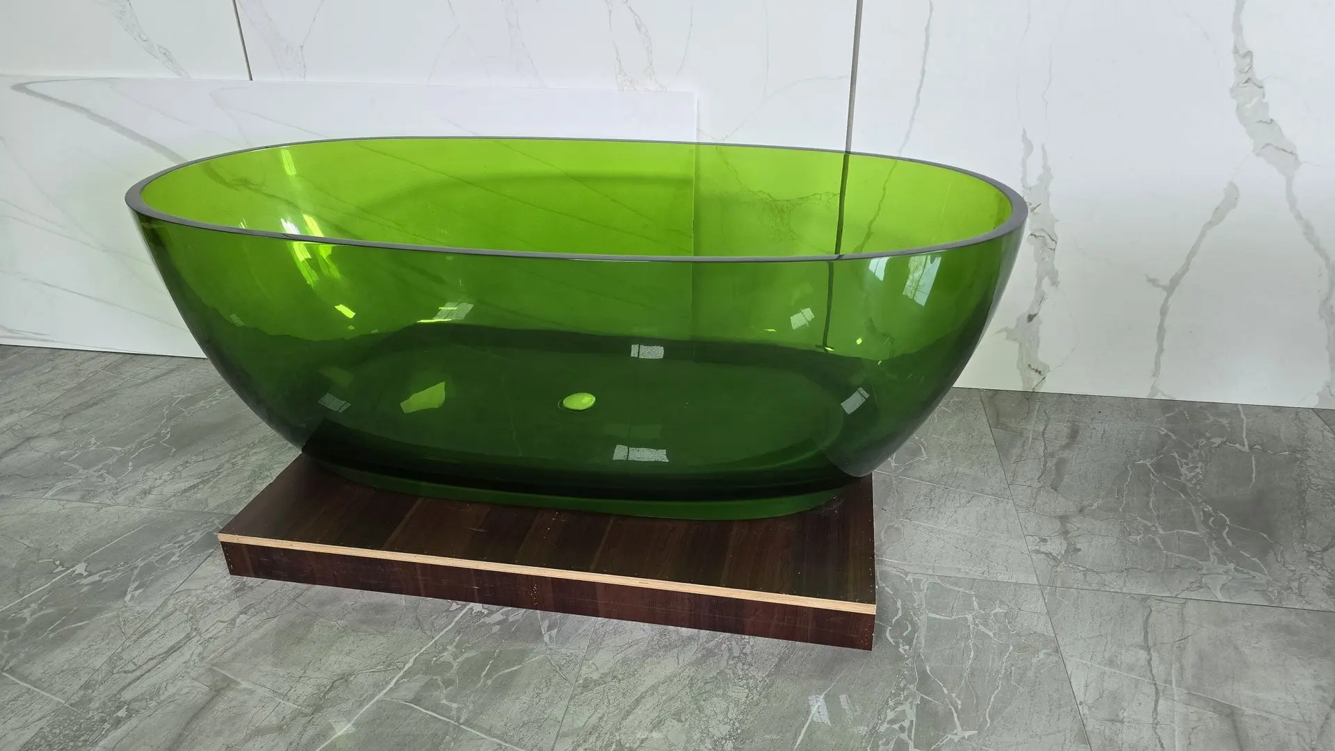 Green transparent freestanding bathtub showcasing custom color and design flexibility for high-end bathroom interiors