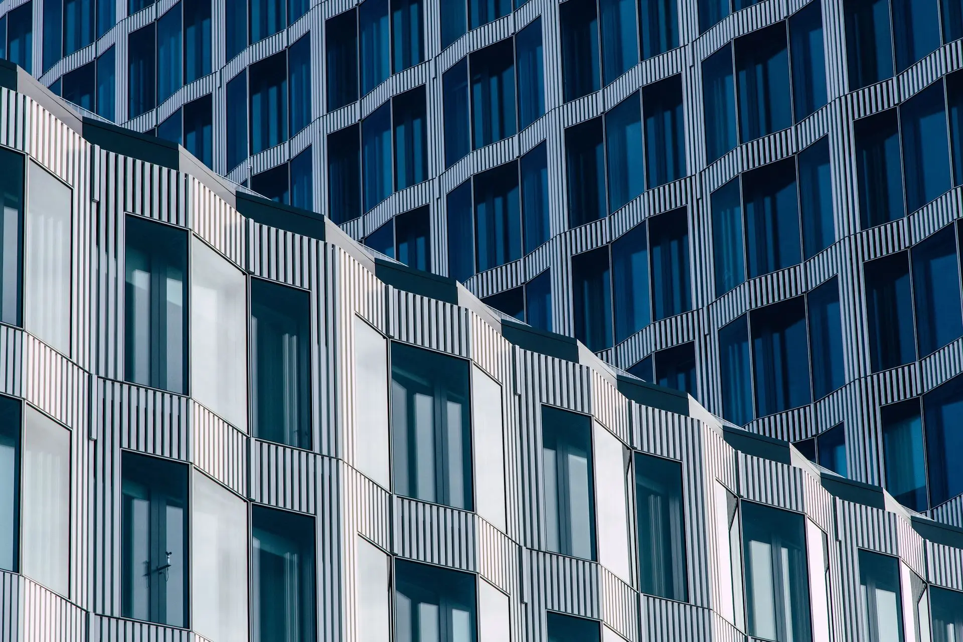 Low-E Glass Benefits for Energy-Efficient Buildings Energy-efficient building featuring Low-E glass windows for reduced heating and cooling costs