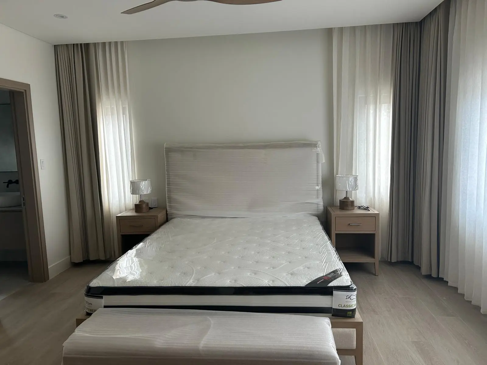 160 Atlantic bedroom with upholstered bed, bedside tables, curtains, and SPC flooring sourced by Guangzhou Sourcing