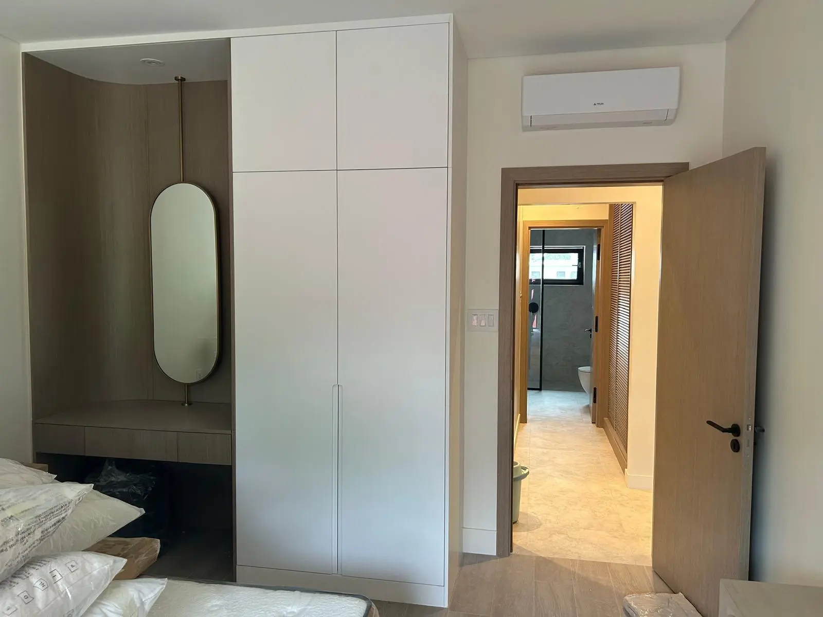 160 Atlantic bedroom wardrobe and vanity area featuring custom cabinetry, mirror, and storage solutions