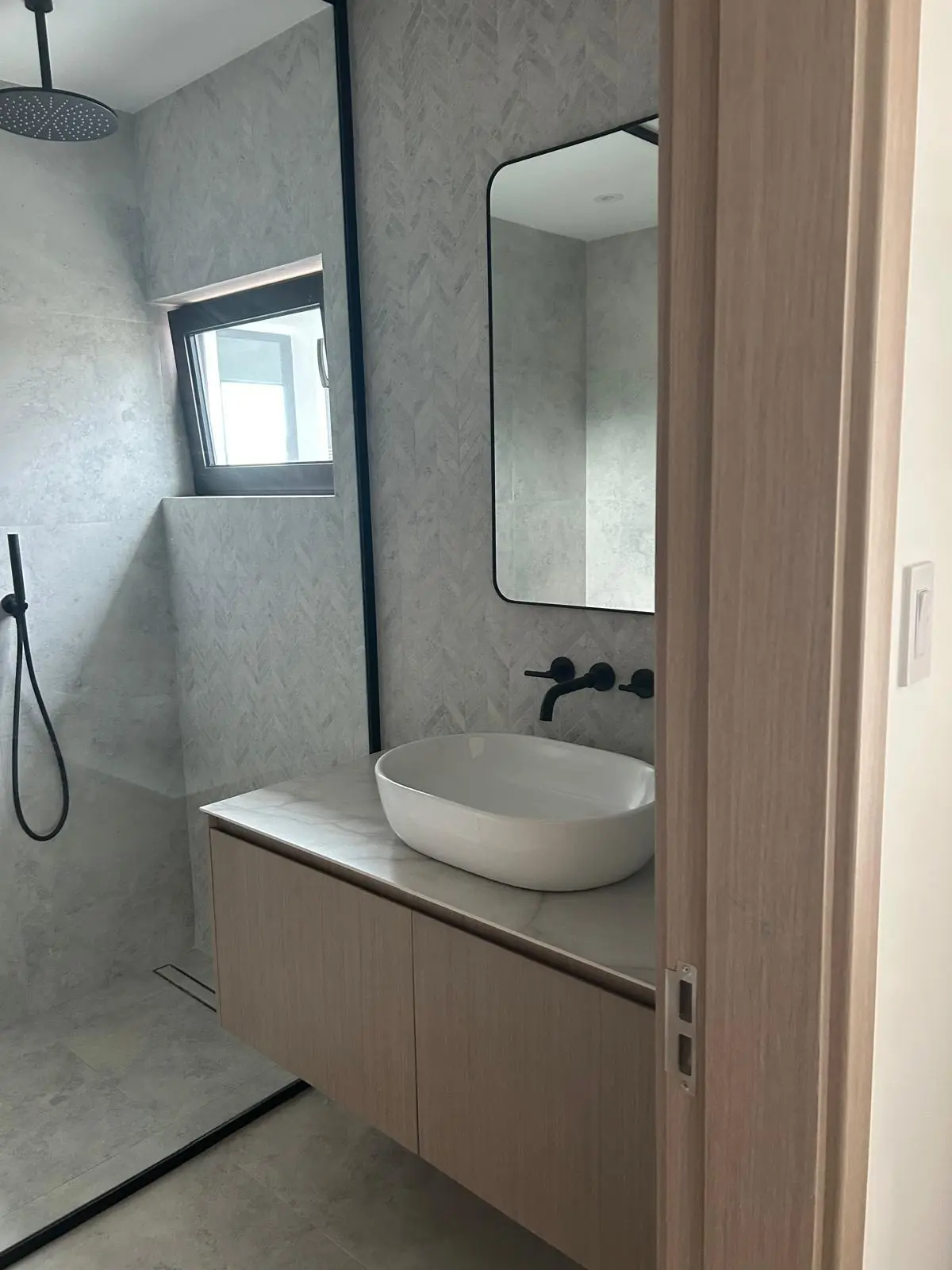 160 Atlantic bathroom showcasing a floating vanity, mirror, shower partition, and modern sanitary ware