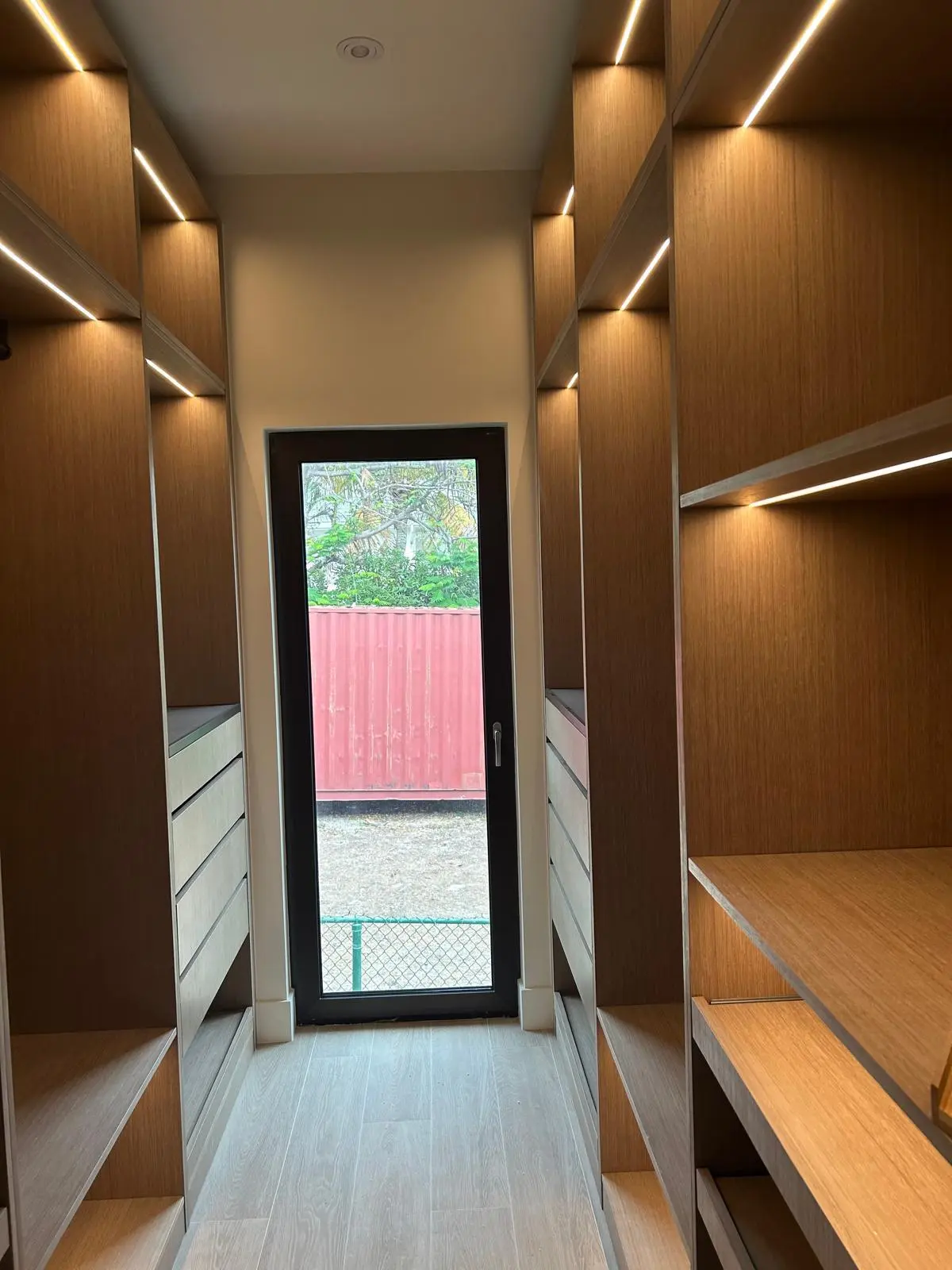 160 Atlantic dressing room with bespoke millwork, shelving, and integrated lighting for organized storage