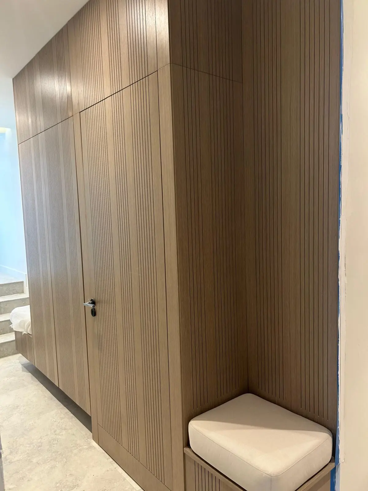 160 Atlantic built-in wardrobe with custom wood millwork and integrated seating area