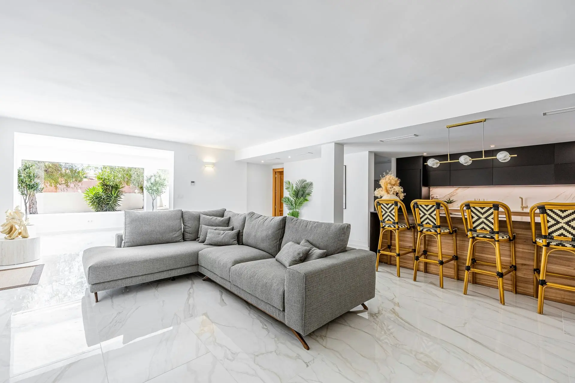 FF&E Procurement for Villas | Luxury Furniture, Fixtures and Equipment Solutions Luxury villa interior showcasing FF&E procurement with sectional sofa, bar seating, and premium residential furnishings