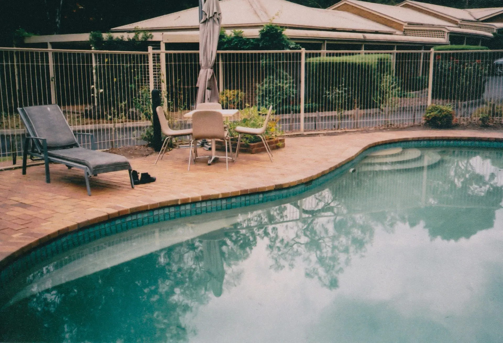 Aluminum swimming pool fencing installed around a residential outdoor pool
