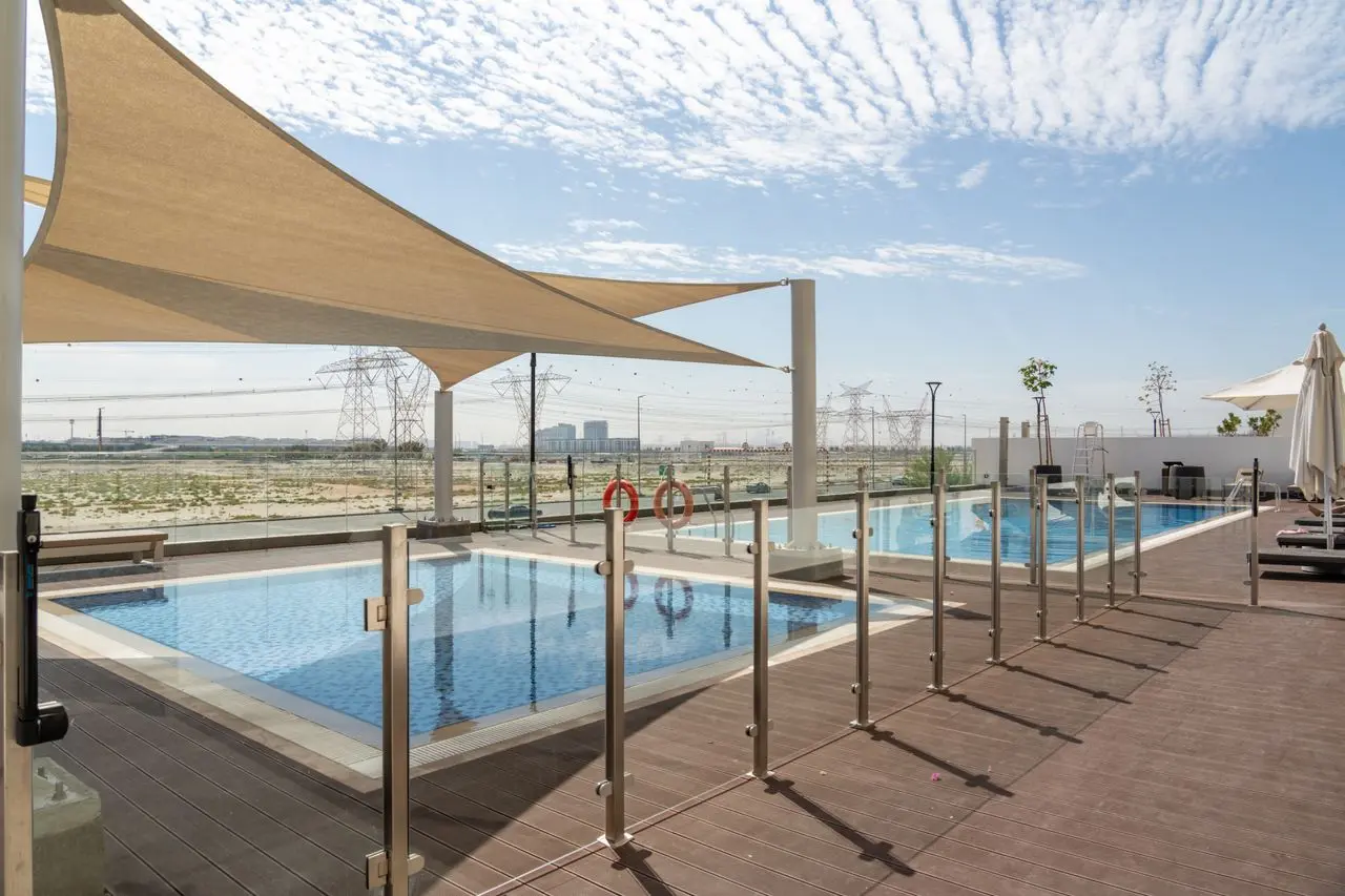 Frameless glass swimming pool fencing with stainless steel hardware showcasing quality materials and professional installation