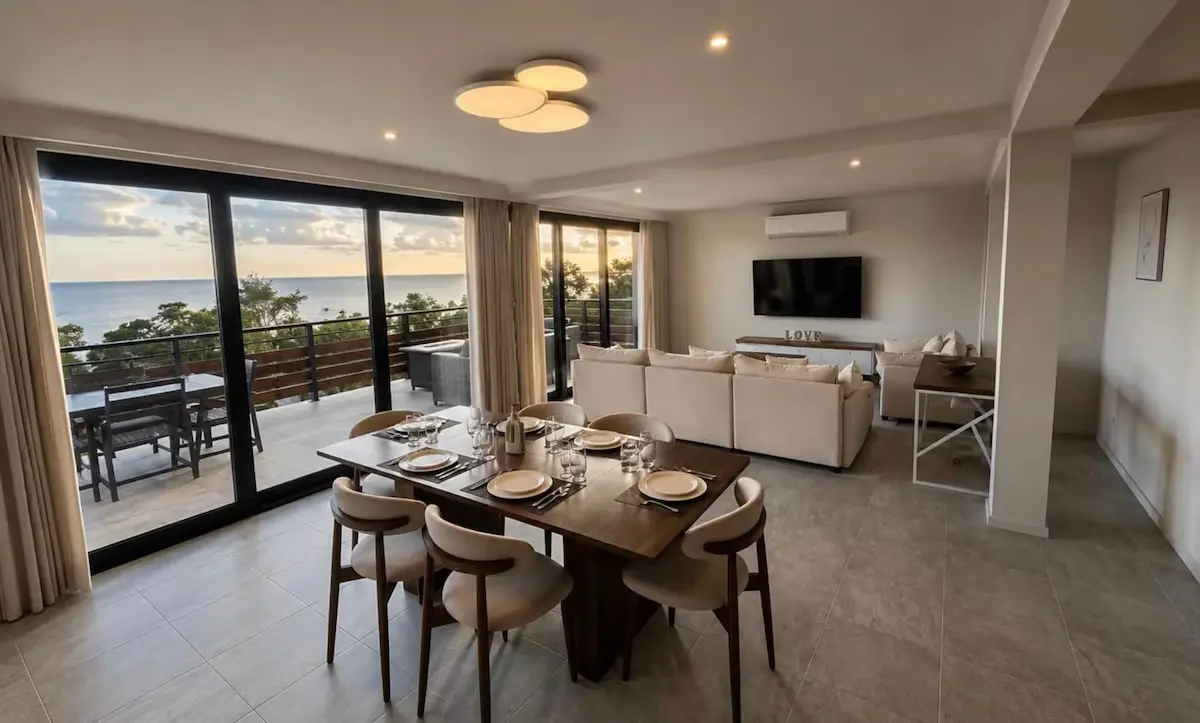 Crystal View modern living room with custom indoor furniture, large windows, and scenic Caribbean views