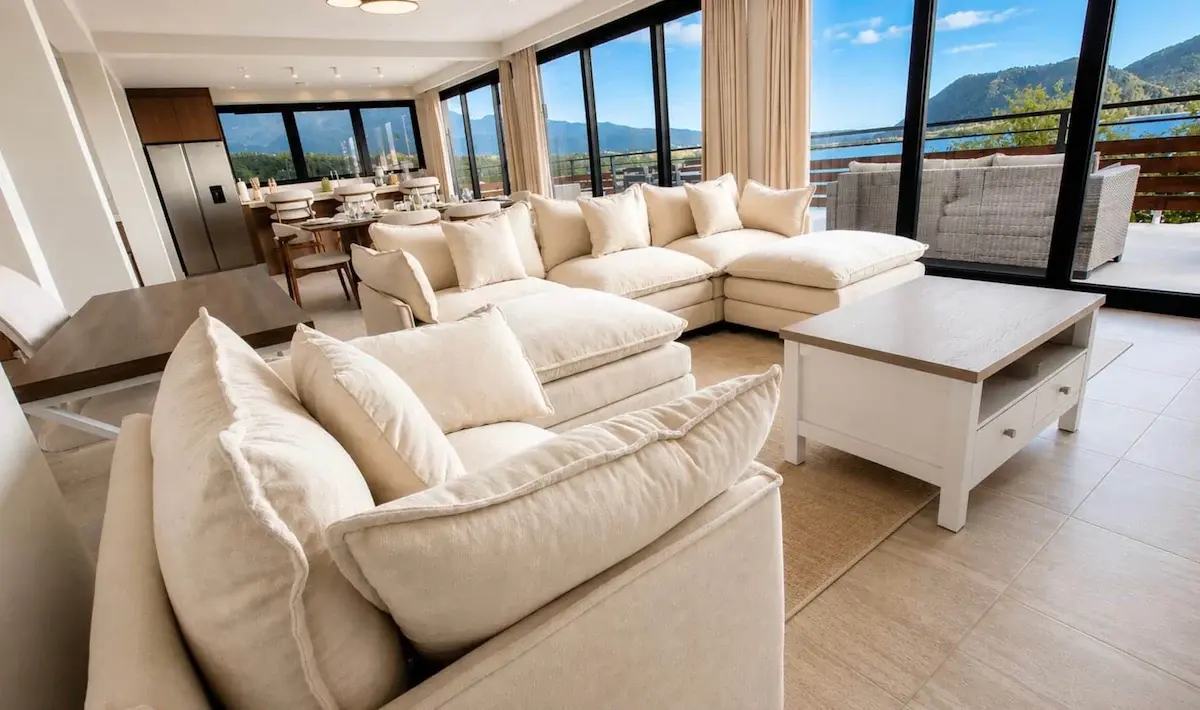 Crystal View living area showcasing luxury sectional sofa, custom furnishings, and expansive windows overlooking the sea
