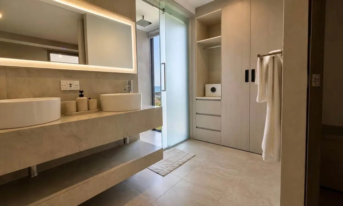 Crystal View luxury bathroom featuring custom vanity, sanitary ware, walk-in shower, and modern cabinetry in Dominica