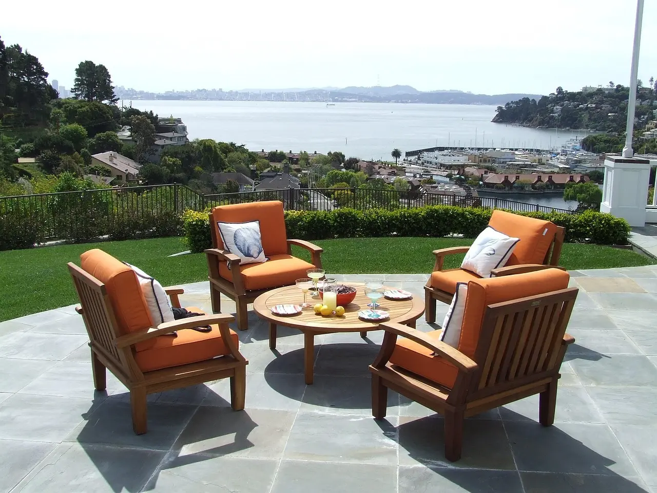 Teak Outdoor Furniture Lounge Chairs for Patios and Resorts Teak outdoor furniture lounge chairs and coffee table overlooking a waterfront patio