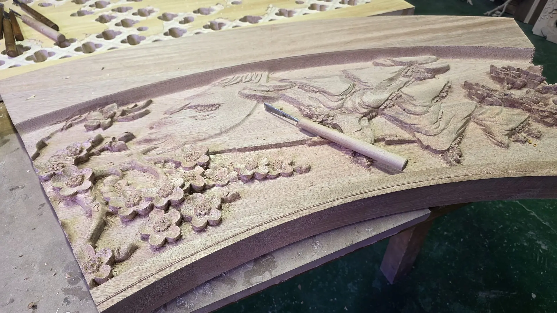 Hand-Carved Wood Carving vs. CNC Wood Carving Comparison Hand-carved decorative wood panel with intricate floral relief demonstrating traditional wood carving craftsmanship