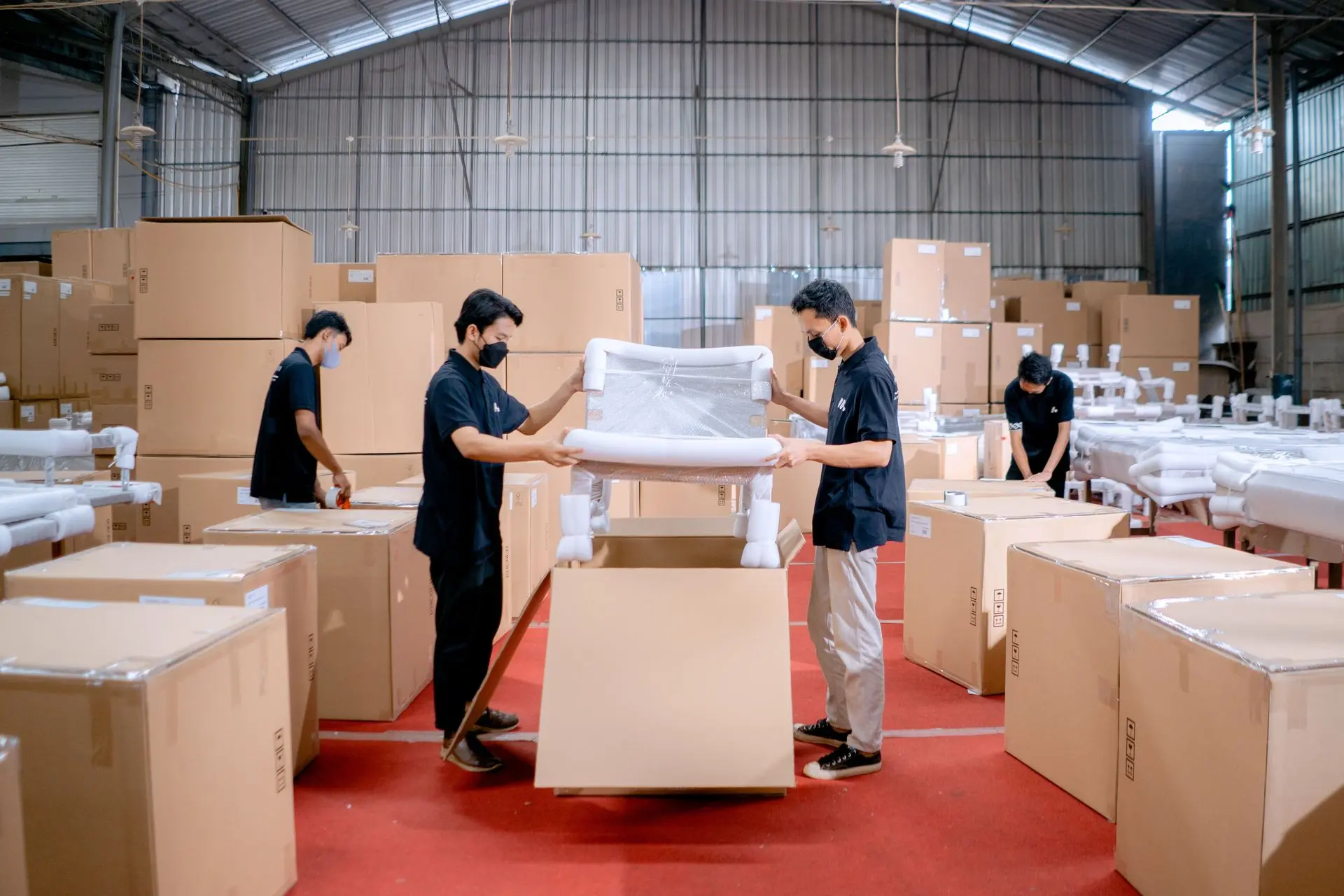 Luxury Furniture Manufacturing and Export from China Furniture workers packaging luxury furniture for international export from a manufacturing facility