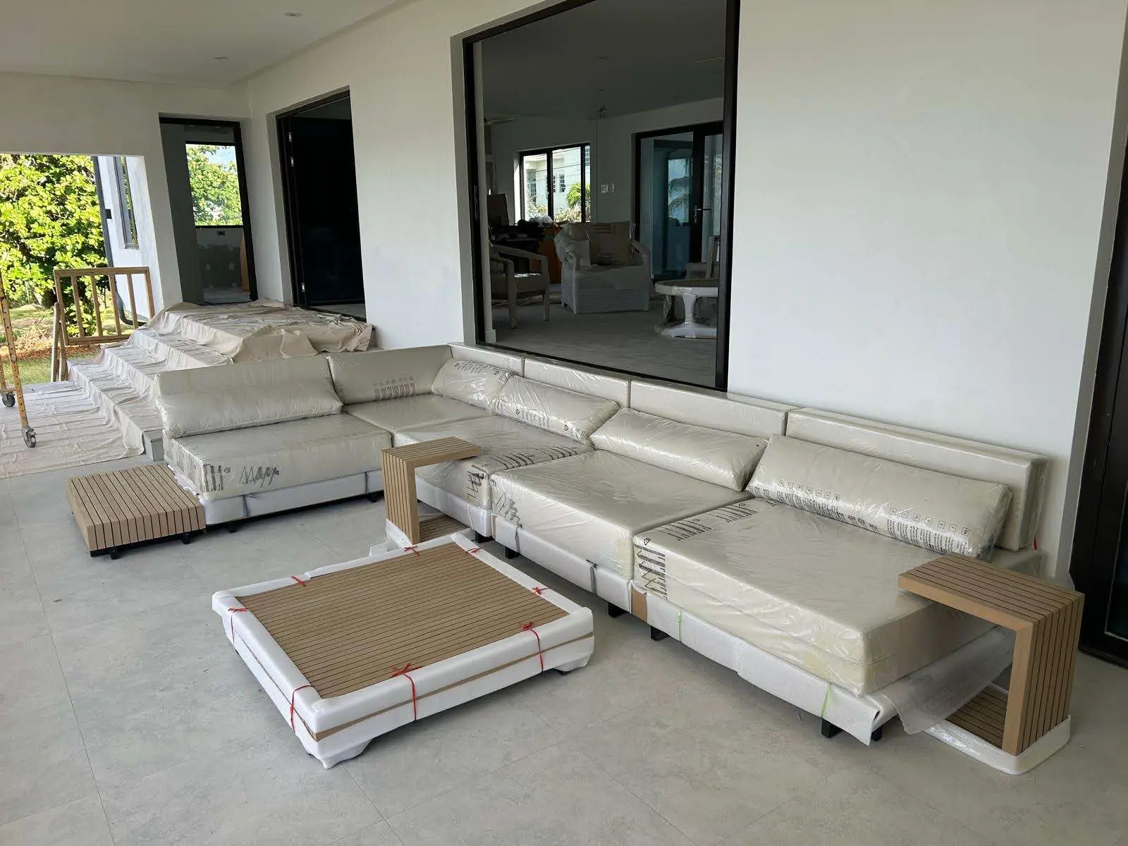 Outdoor RH-inspired furniture delivered to a project site in protective packaging from China