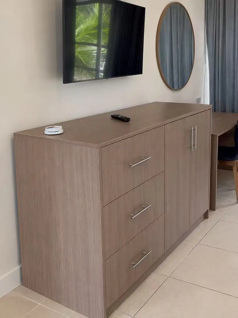 Hotel guest room chest of drawers with television and custom wooden cabinetry