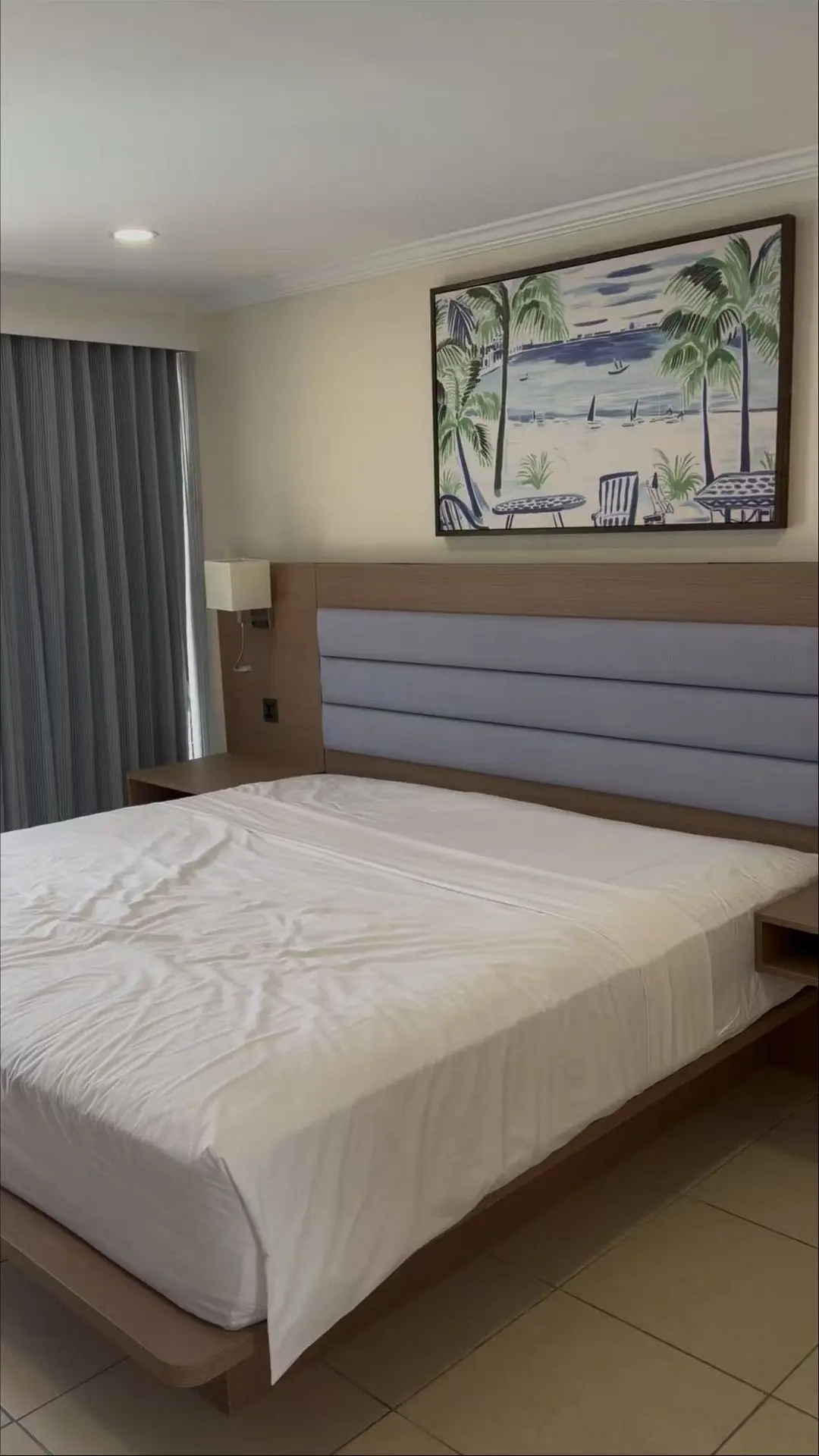 Modern guest room with upholstered headboard, bedside tables and custom hotel furniture