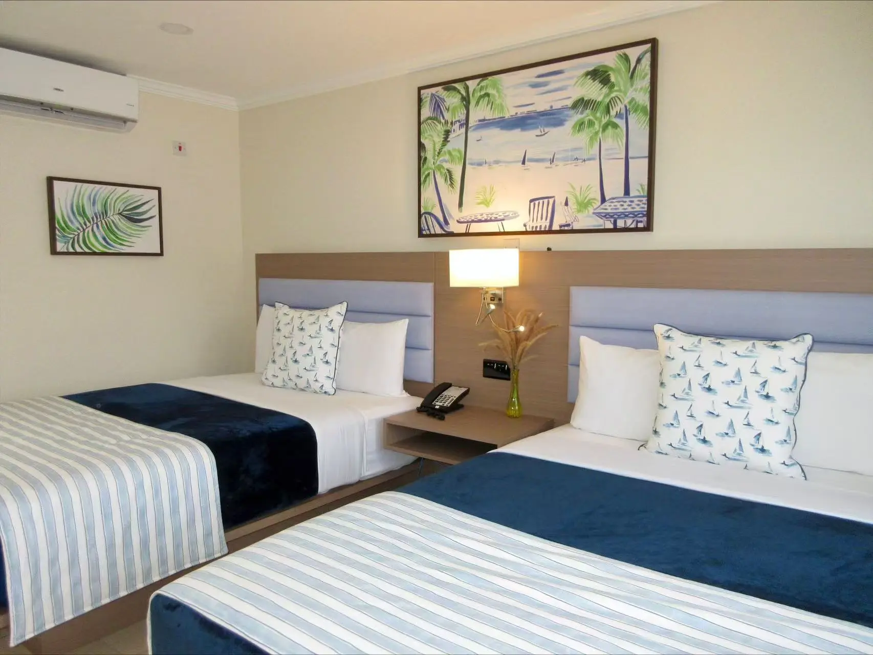 Twin bed guest room featuring custom hotel furniture and modern interior design