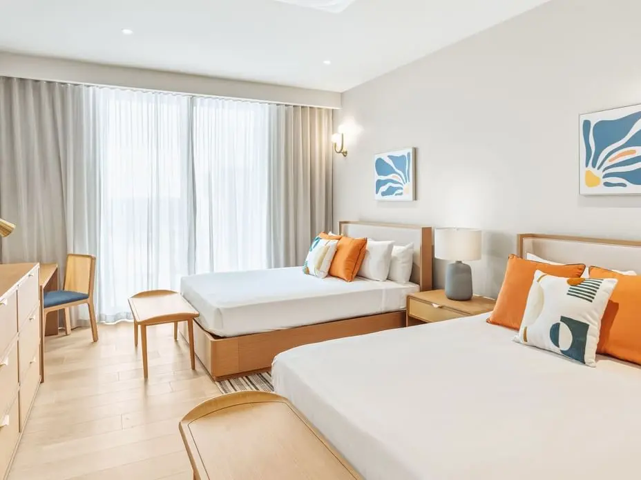 Twin bedroom with contemporary furniture and bright coastal-inspired interior