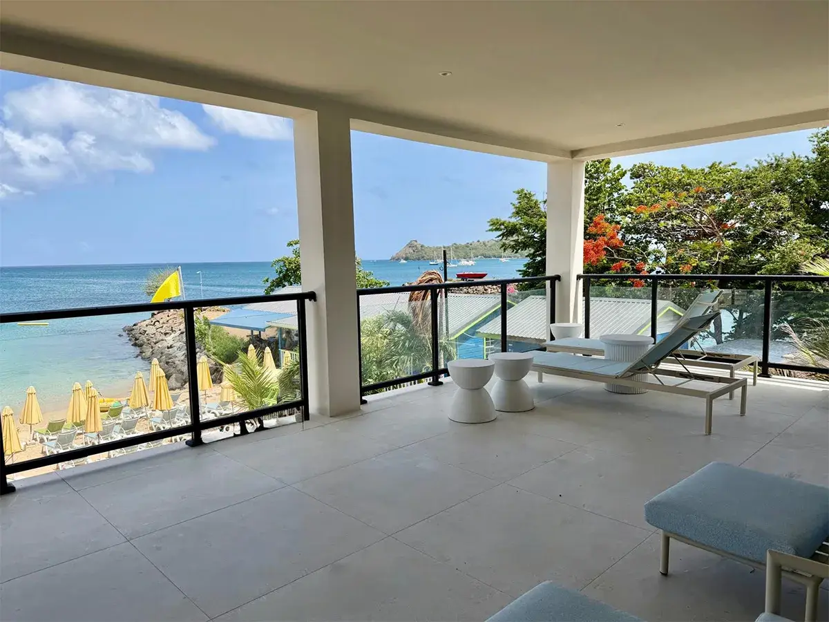 Private villa balcony with outdoor seating and panoramic ocean views at Sapphire Sands Villas