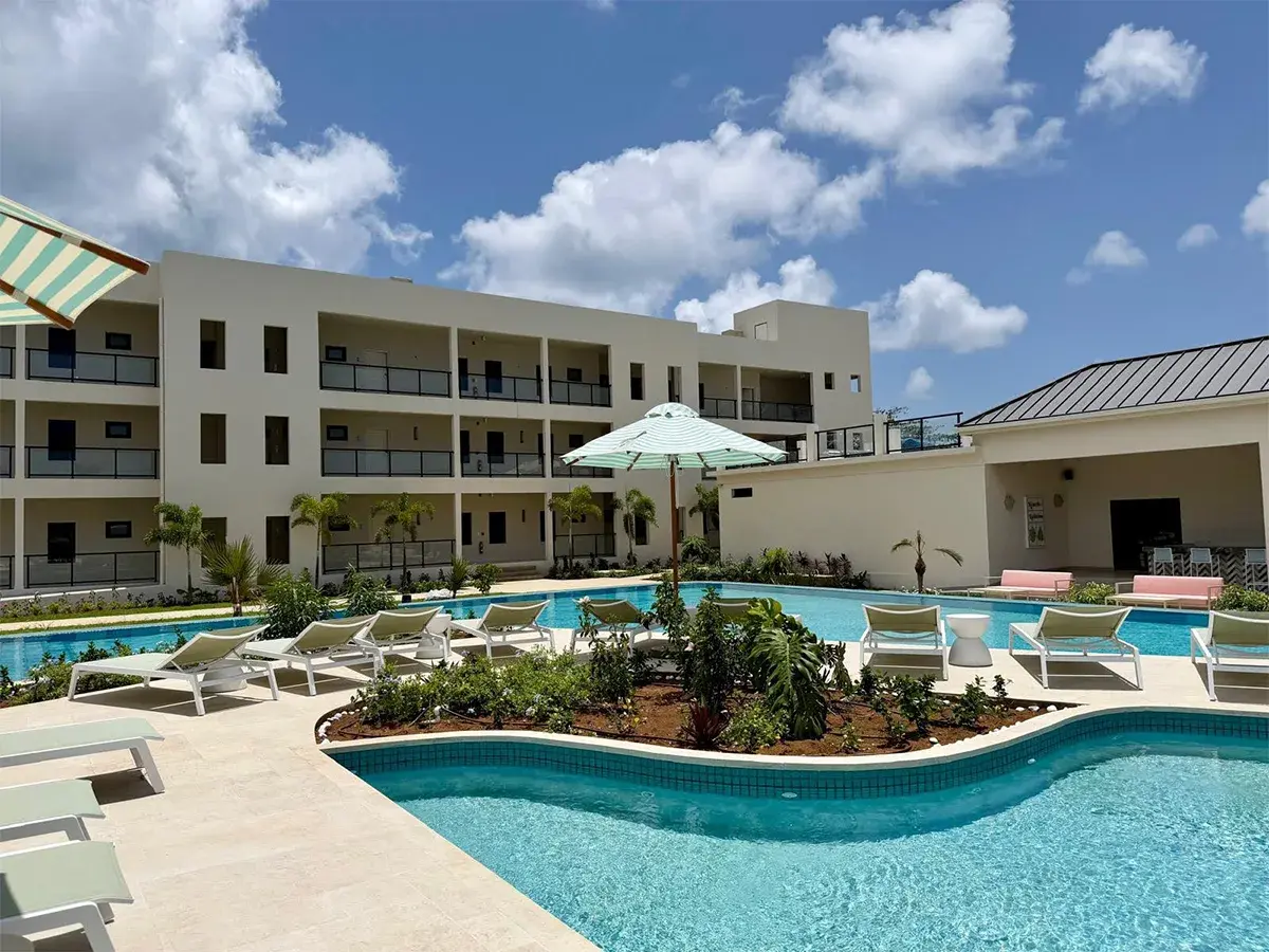 Resort-style swimming pool with sun loungers and landscaped outdoor amenities at Sapphire Sands Villas