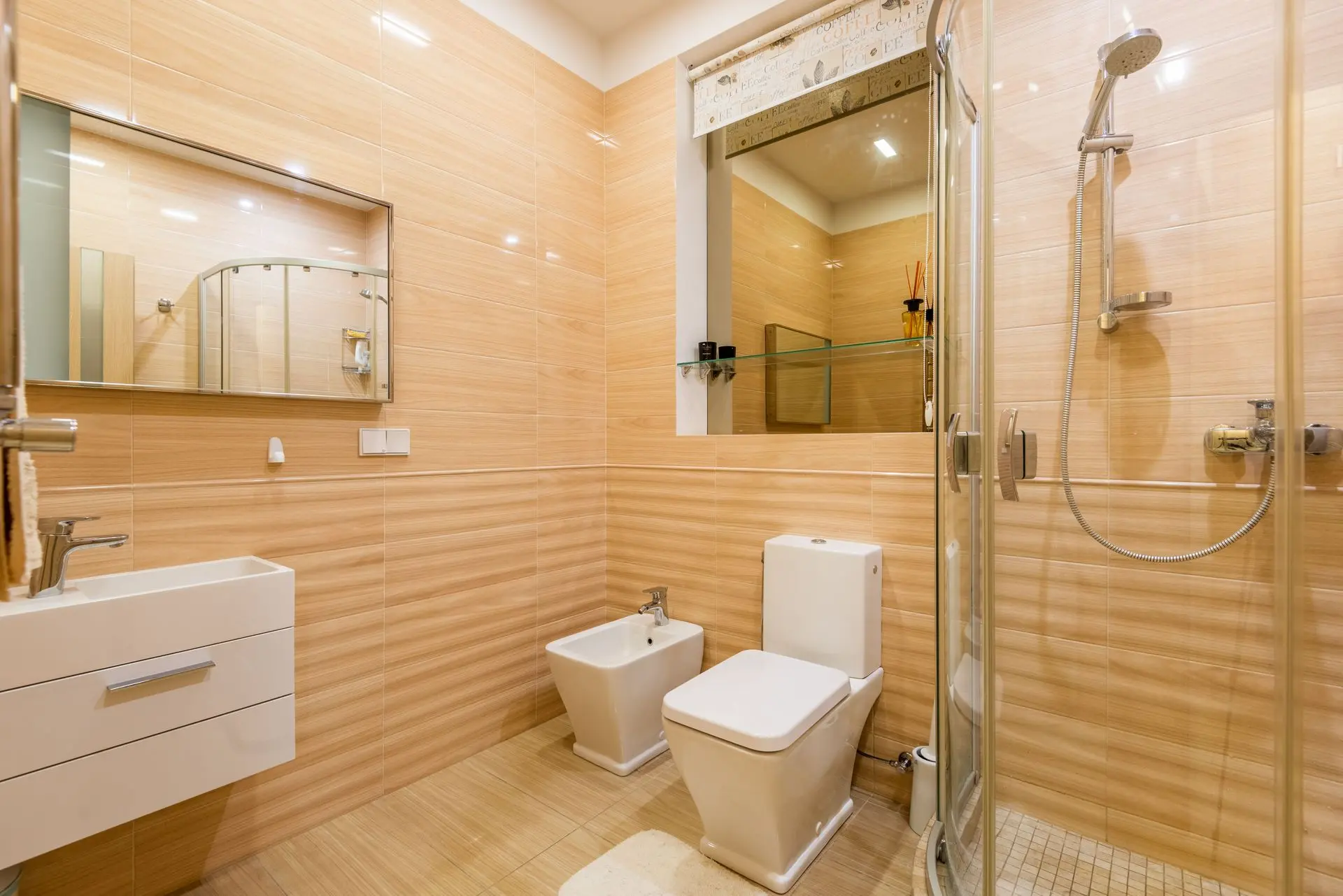Two-piece ceramic toilet with separate tank and bowl in a modern bathroom