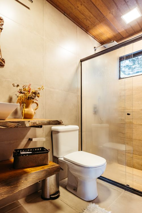 Two-piece ceramic toilet installed in a modern residential bathroom