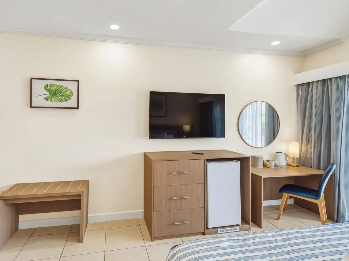 Bay Gardens Marina Haven guest room TV console with drawers, storage cabinet and wooden bench