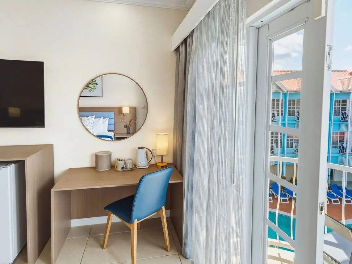 Bay Gardens Marina Haven guest room writing desk with round mirror, chair and custom furniture