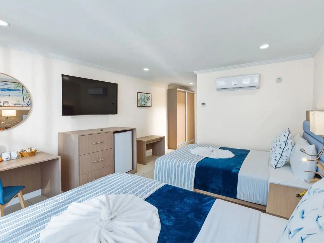 Bay Gardens Marina Haven twin guest room with TV, storage cabinet and contemporary furnishings