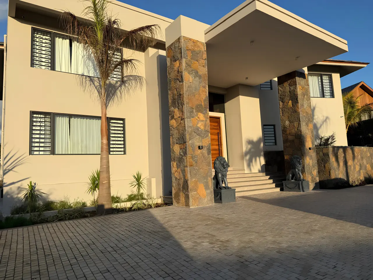 Modern residential villa exterior in Mauritius with landscaped entrance and contemporary architecture