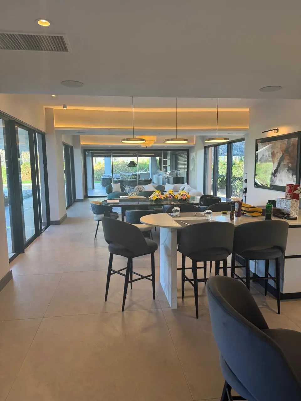 Residential villa dining area in Mauritius with modern dining chairs, table and contemporary lighting