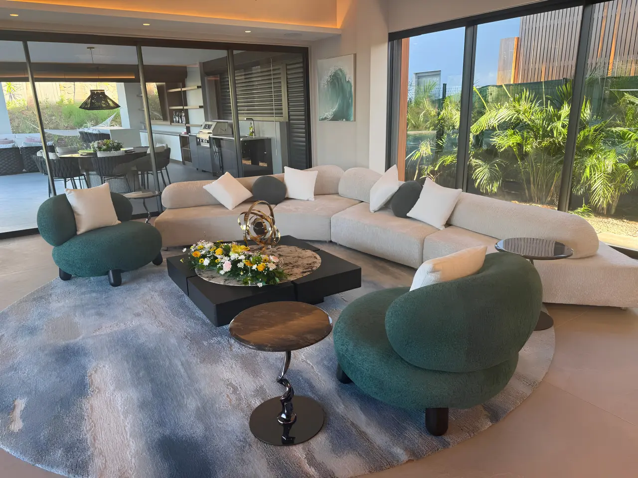 Modern residential villa living room in Mauritius with custom sofas, lounge chairs, coffee table and carpet