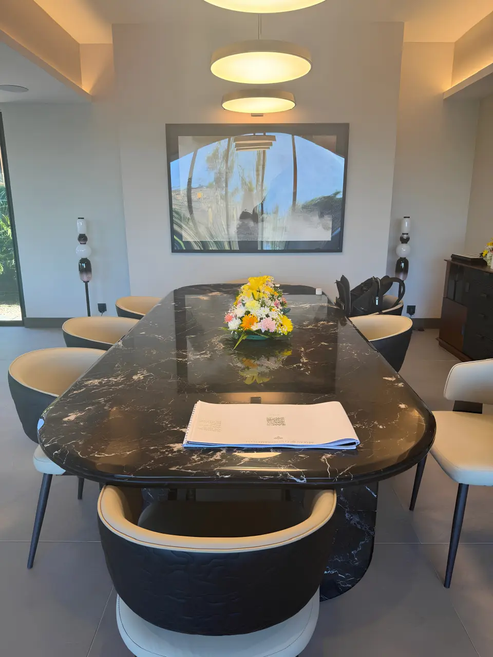 Luxury villa dining room in Mauritius with marble dining table, upholstered chairs and decorative lighting