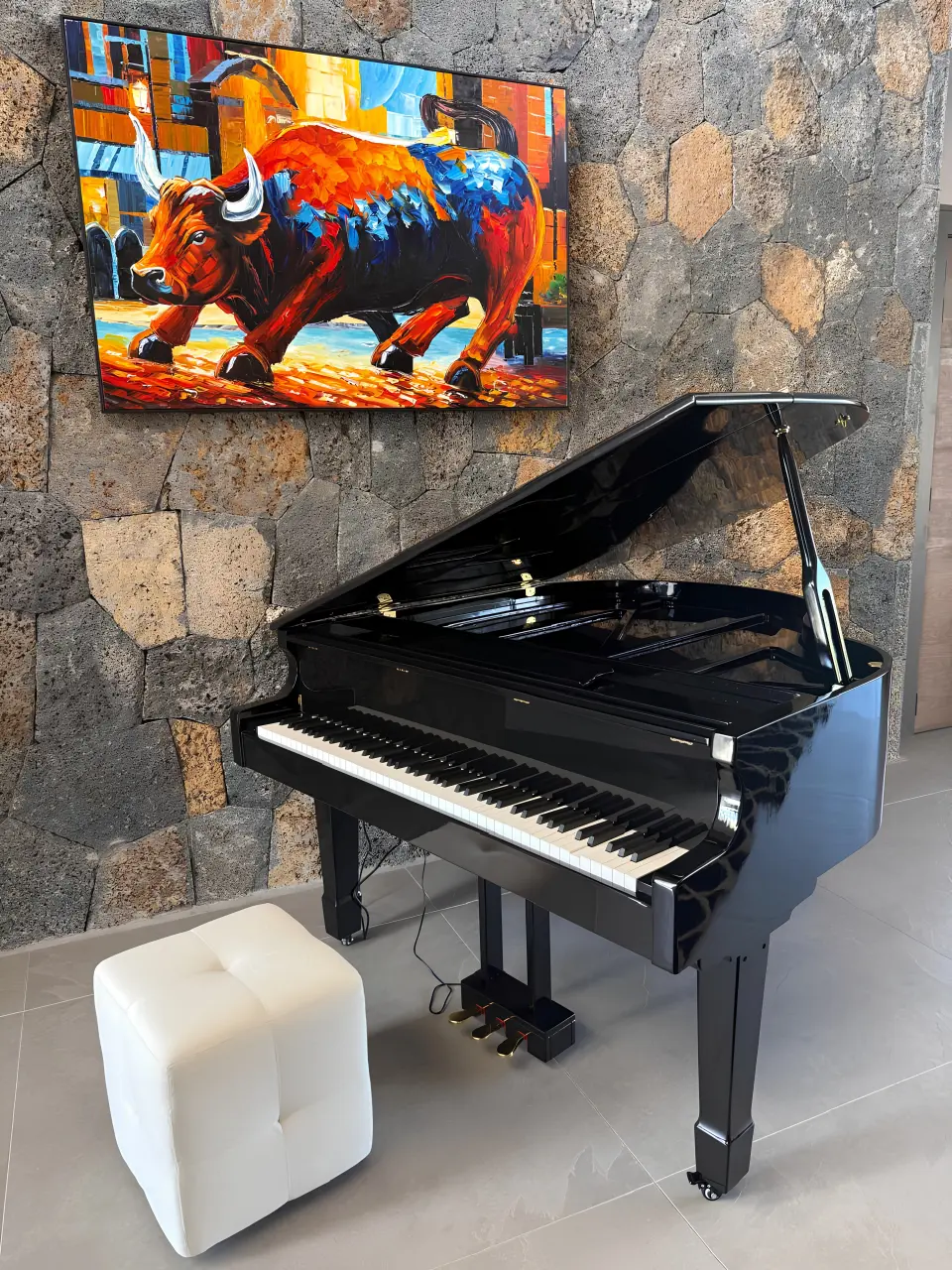 Residential villa piano area with grand piano, wall-mounted artwork and stone feature wall in Mauritius