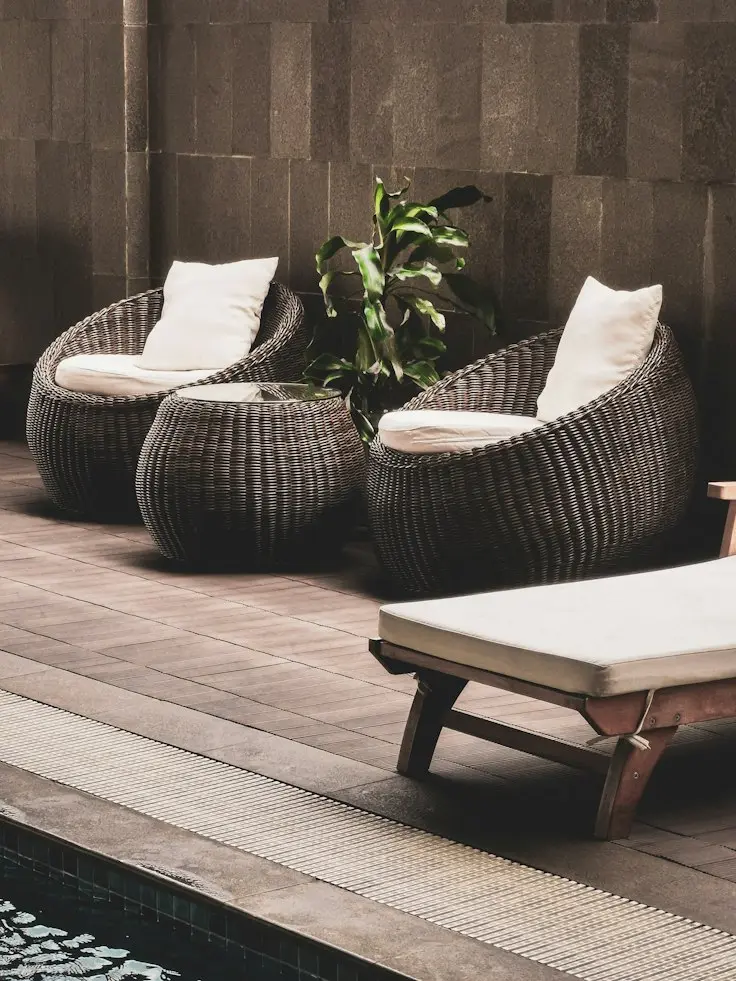 PE rattan wicker patio chairs with woven design beside a pool