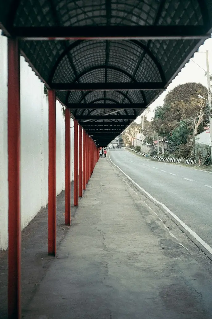 Fixed canopy covering a pedestrian walkway along a roadside