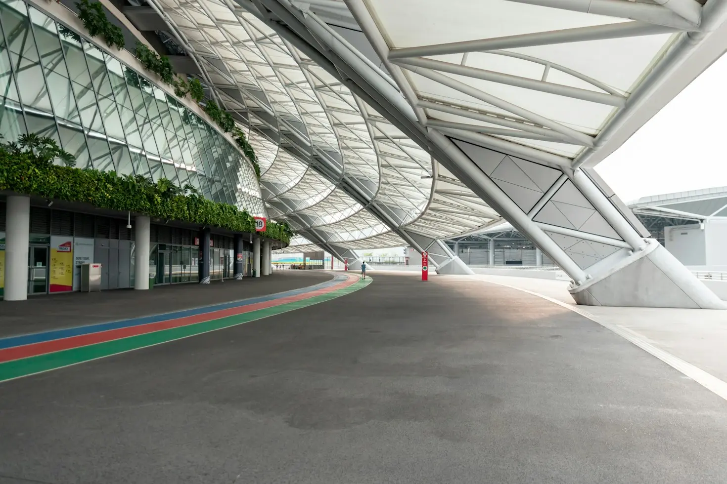 Large architectural canopy covering a pedestrian area at a commercial facility